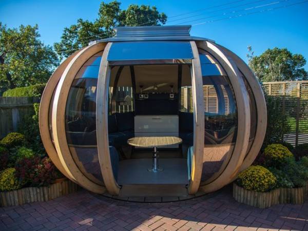 garden pods - photo of a big graden pod with glass, seats and a table.