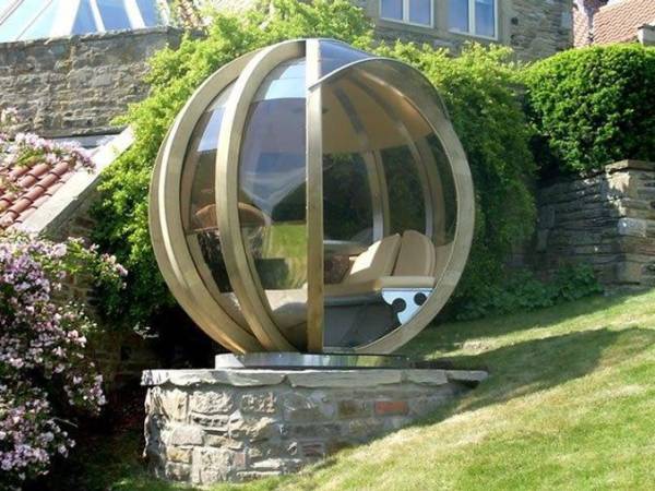 garden pods - photo of a rotating lounge garden pod with glass walls.